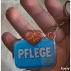 Acryl-Schlüsselanhänger "Pflege" mit Herz
