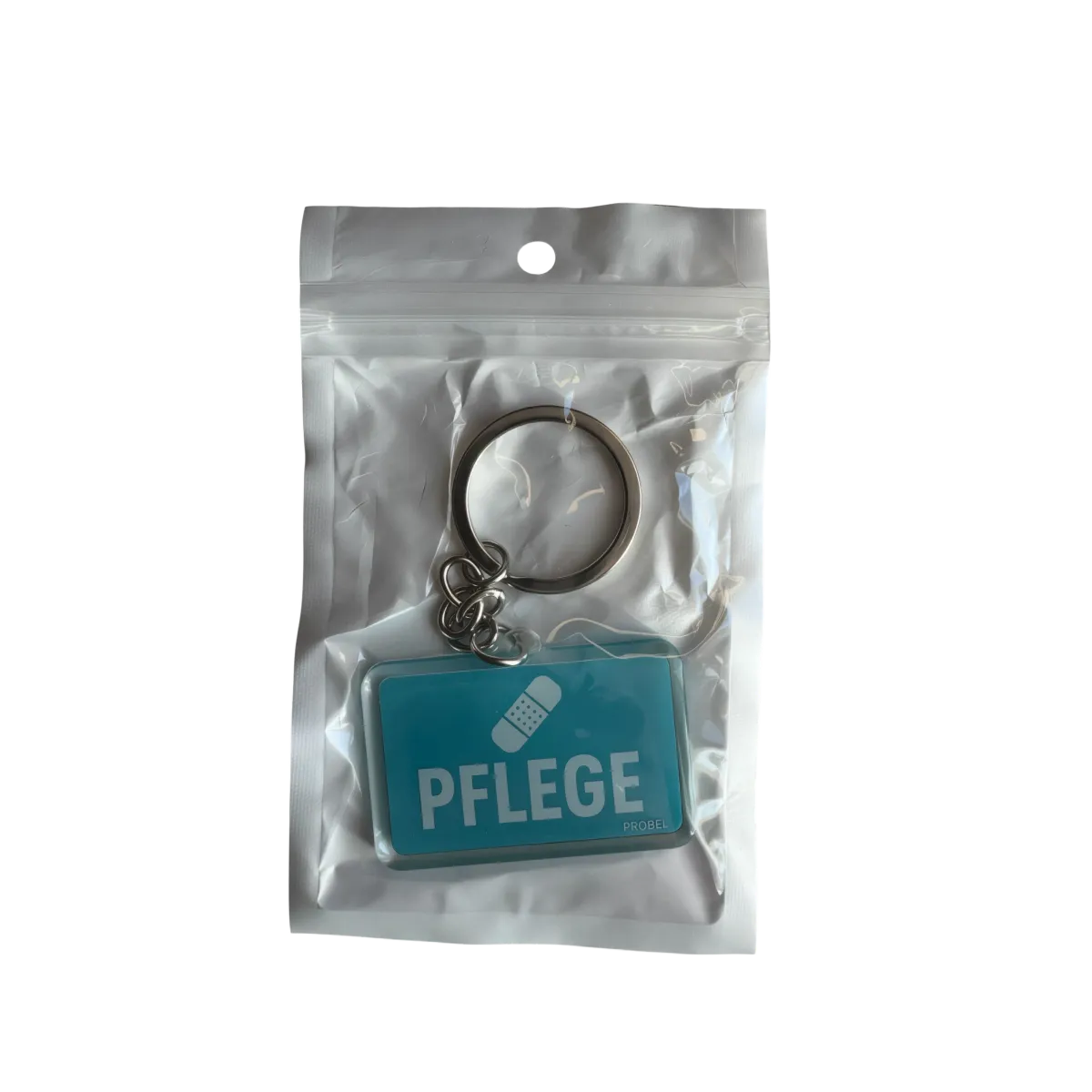 Acryl-Schlüsselanhänger "Pflege" mit Pflaster-Symbol