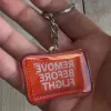 Acryl-Schlüsselanhänger „REMOVE BEFORE FLIGHT“