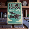 Kovová cedule "Flight School – Learn to Fly"