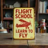 Metallschild Flight School – Learn to Fly (Red Biplane)