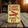 Metallschild Flight School – Learn to Fly (Red Biplane)